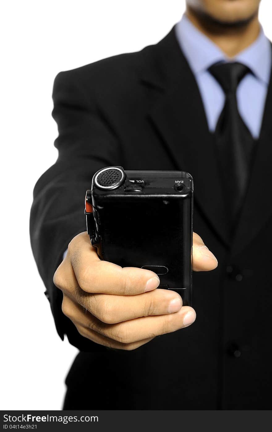 Businessman speaking into a dictaphone recorder over white background. Businessman speaking into a dictaphone recorder over white background