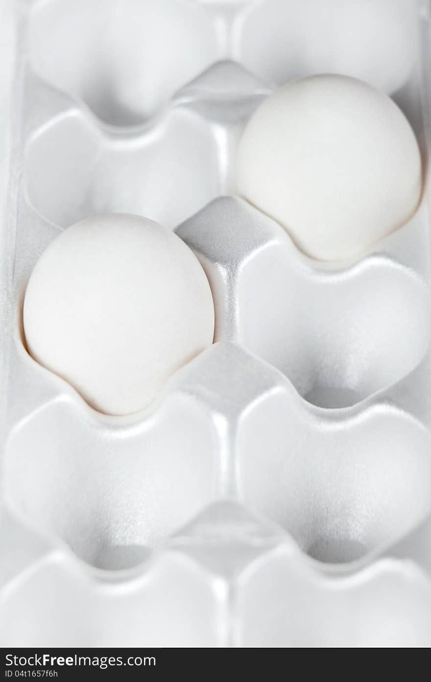 Two white eggs in packing for storage. Two white eggs in packing for storage