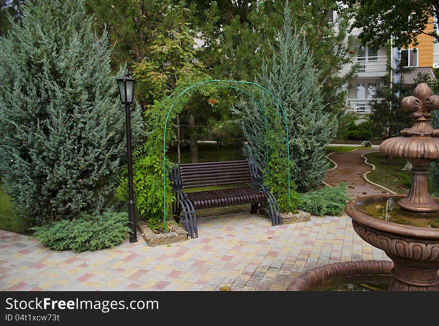 Fine bronze Fountain in park among trees