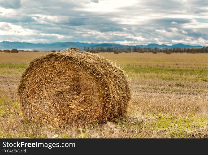 Haystack on a background of mountains in October