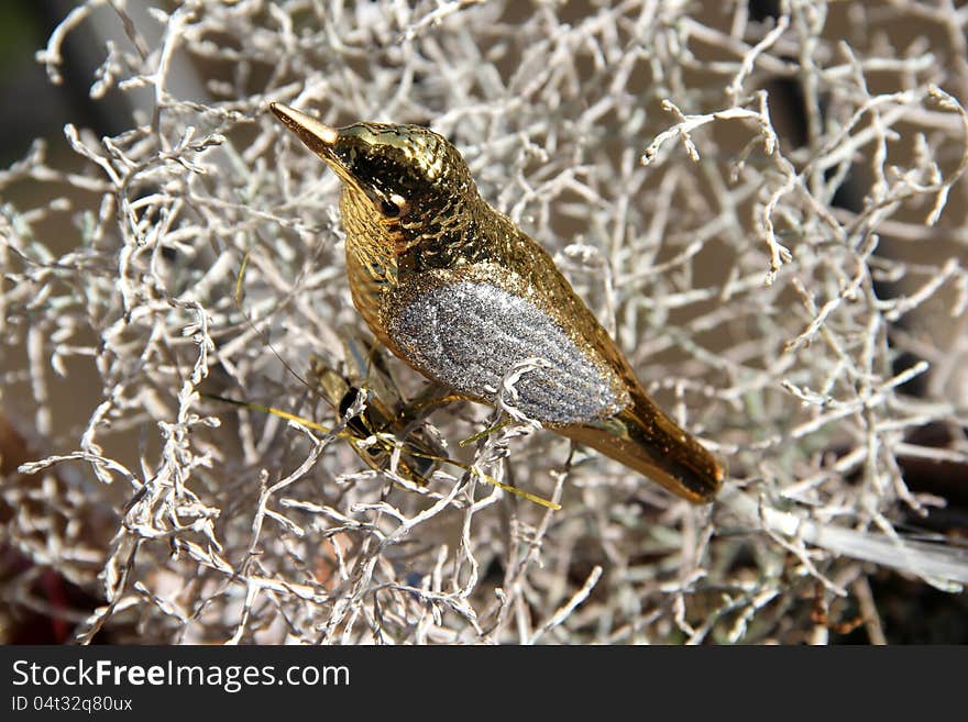 Christmas decorations - white branch with golden bird. Christmas decorations - white branch with golden bird