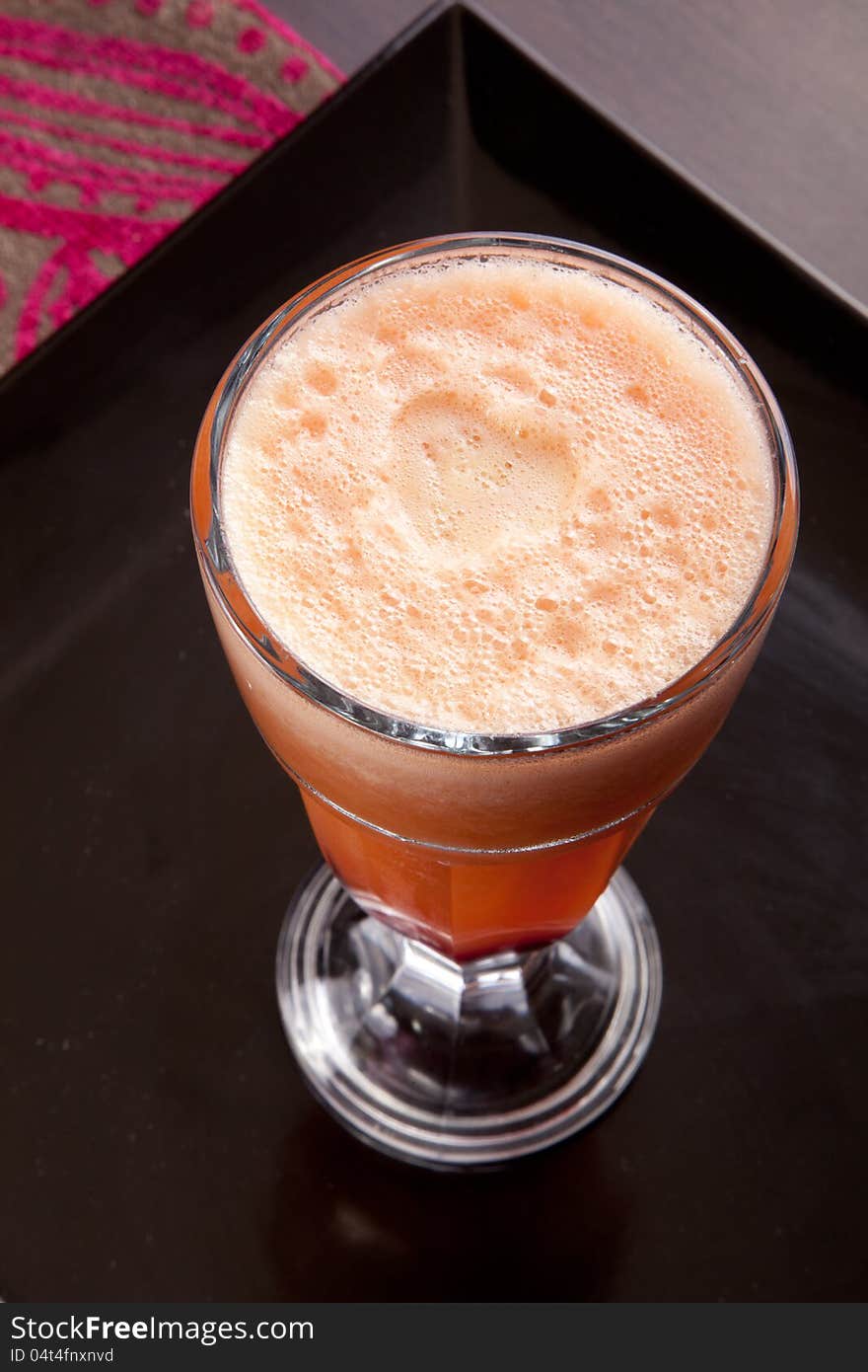 Fresh juice in glass on Black dish. symbol of a healthy lifestyle. Fresh juice in glass on Black dish. symbol of a healthy lifestyle