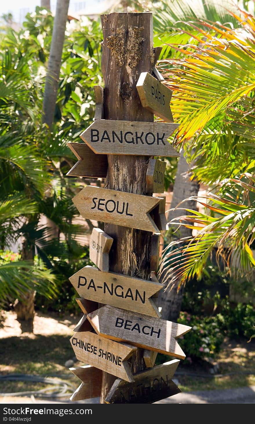 Signpost with arrows on the tropical beach