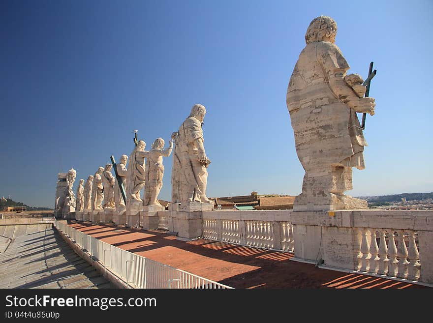 Statues of Jesus and apostles on saint Peter's cathedral roof in Vaticano