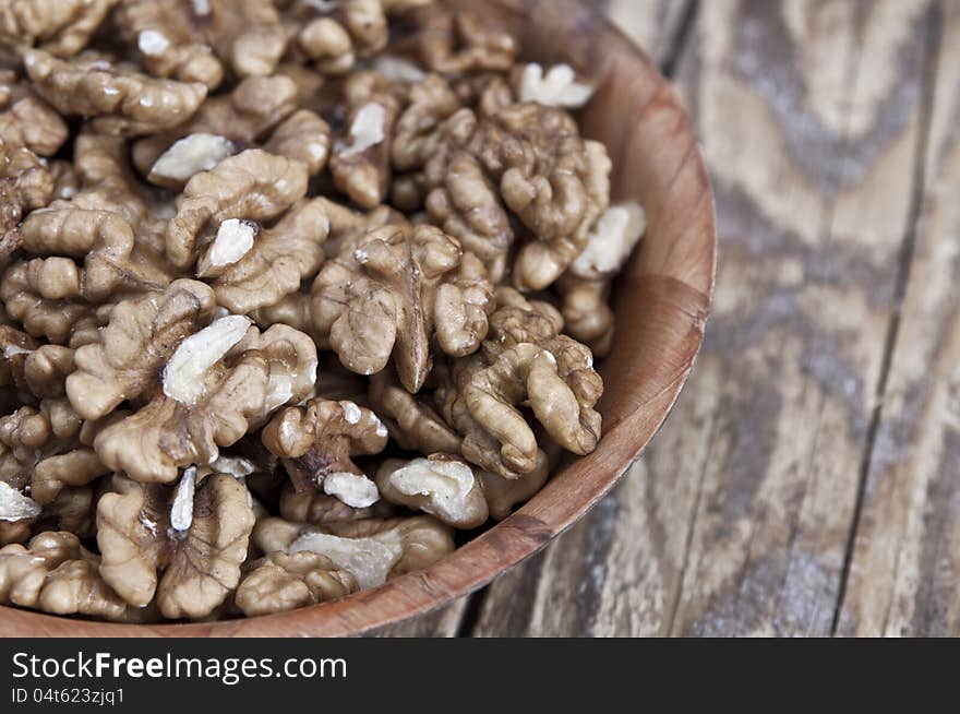 Walnut in wooden bowl on wooden table