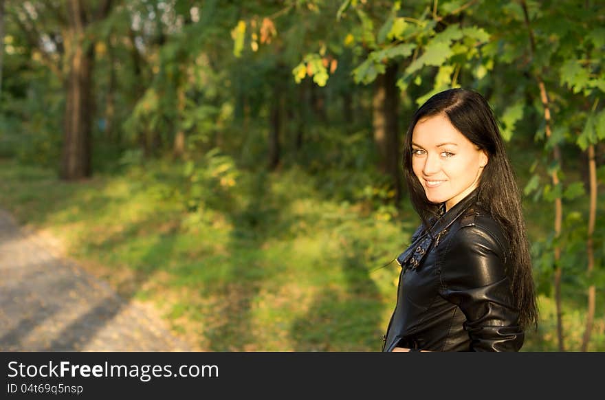 Smiling woman walking through woodland