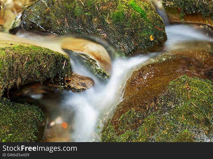 Beautiful veil cascading waterfall, mossy rocks