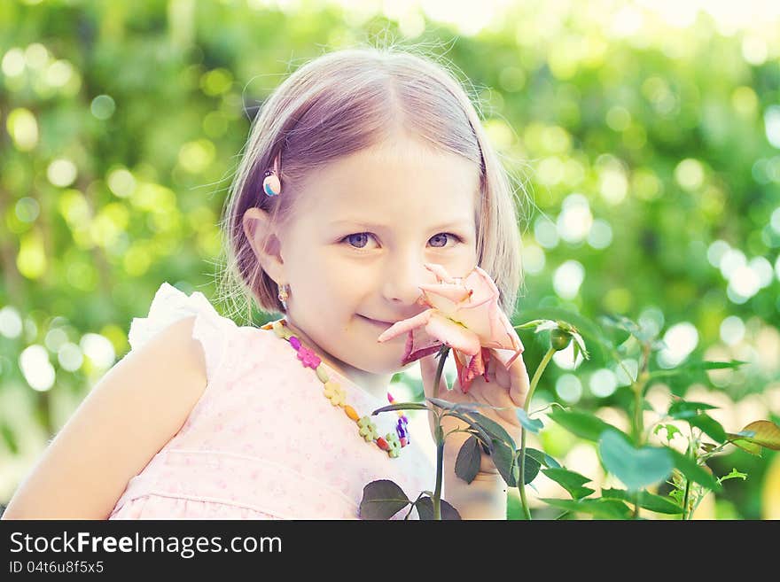 Portrait of a cute little girl smelling a flower. Portrait of a cute little girl smelling a flower