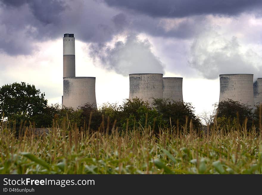 Environmentally non-friendly coal-fired power station in the East Midlands of the UK viewed from a rural perspective with dramatic overhead skies. Copy space.