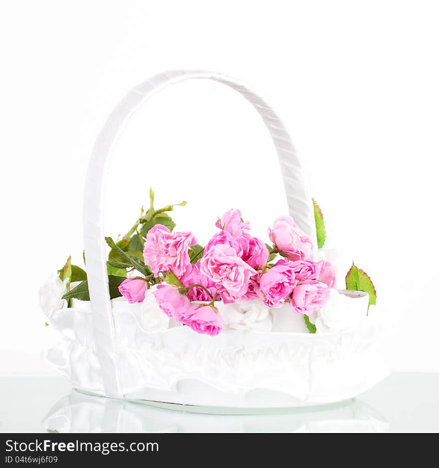 Beautiful pink roses in wedding basket on white background. Beautiful pink roses in wedding basket on white background