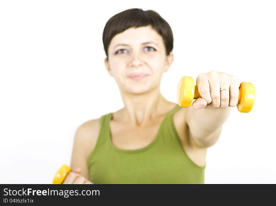 Happy young woman during fitness time and exercising lifting dumbbells. Happy young woman during fitness time and exercising lifting dumbbells