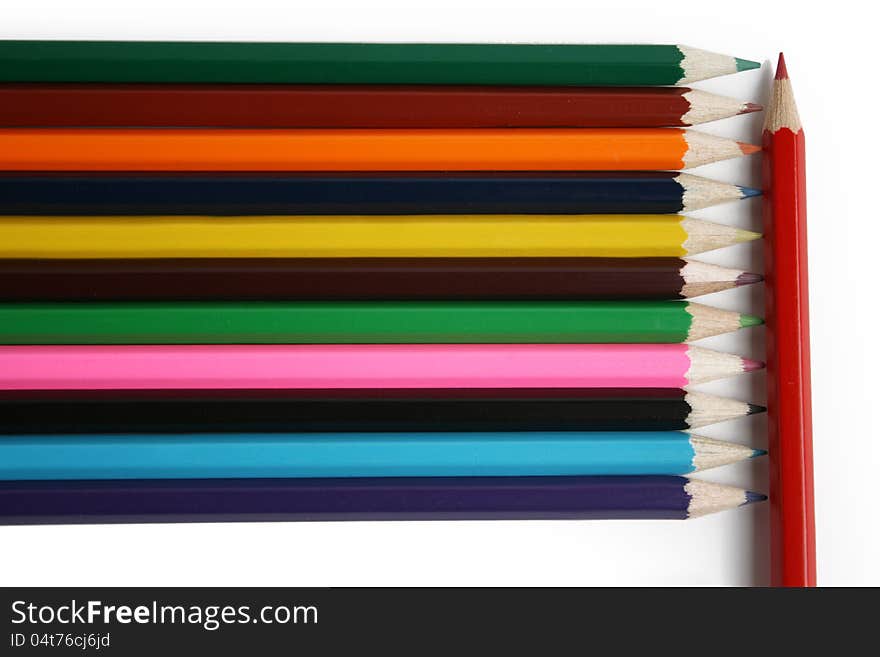 The colored pencils on the white background. The colored pencils on the white background