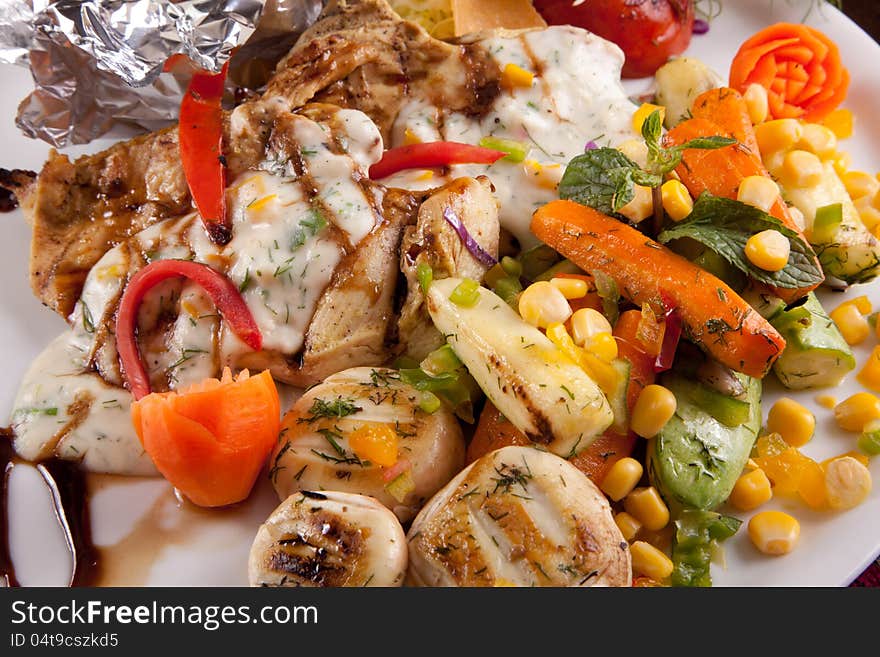 Italian Chicken with Vegetables Meal in white dish Close up. Italian Chicken with Vegetables Meal in white dish Close up