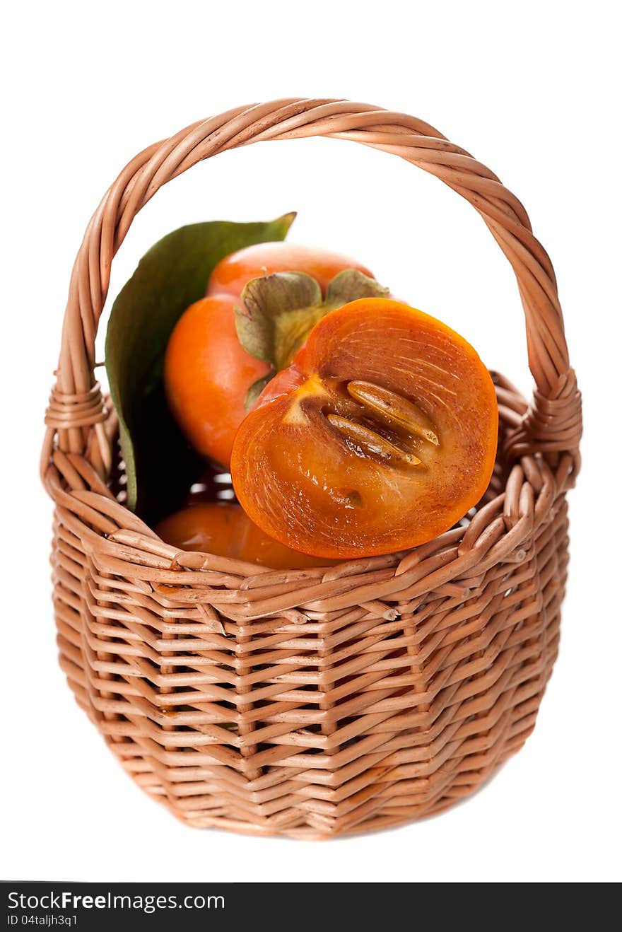 Basket with persimmon on a white background