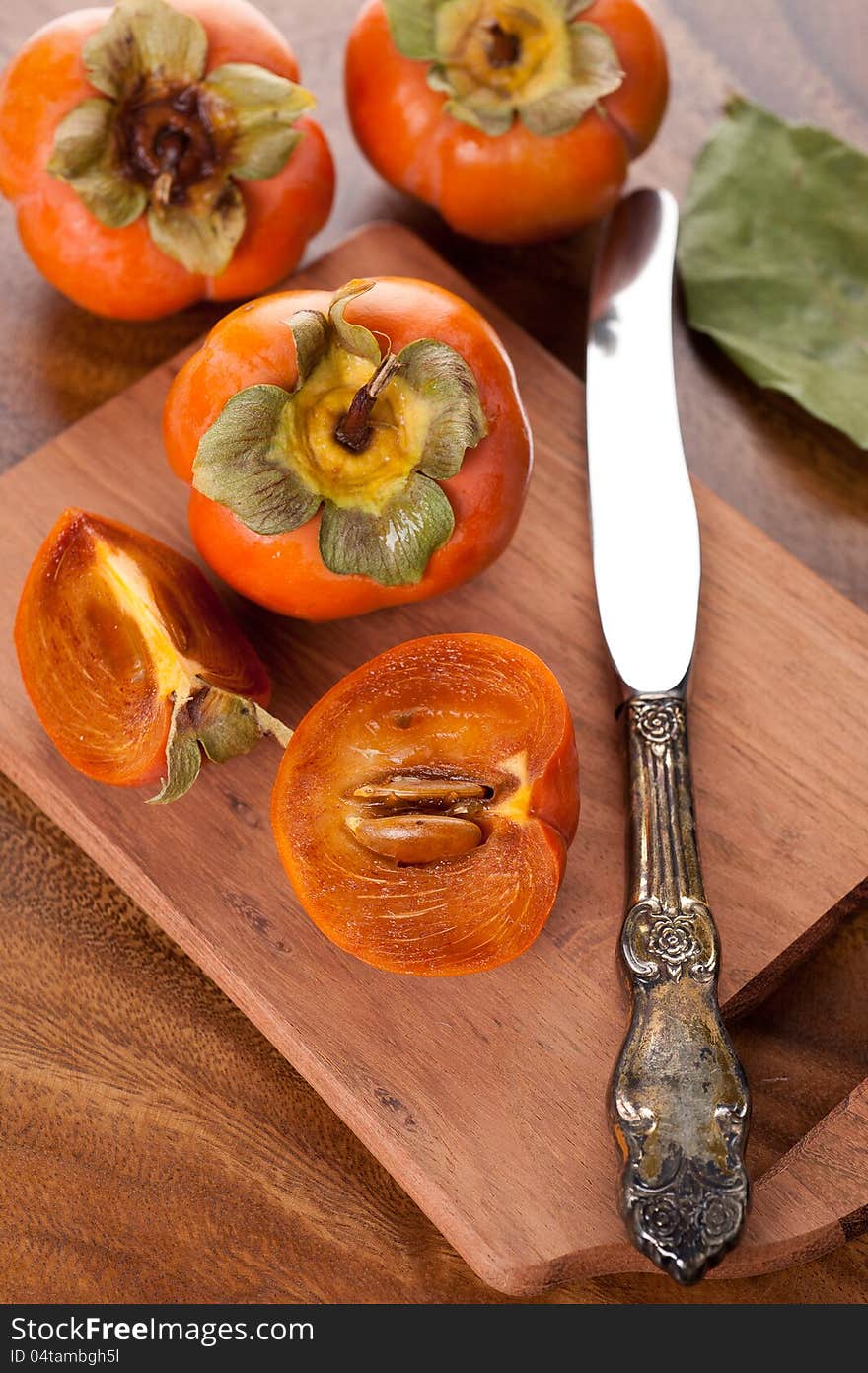 Persimmon On A Wooden Table