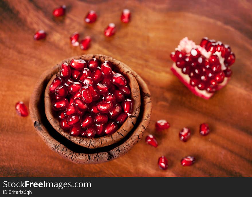 Ripe pomegranate grains in a ceramic bowl