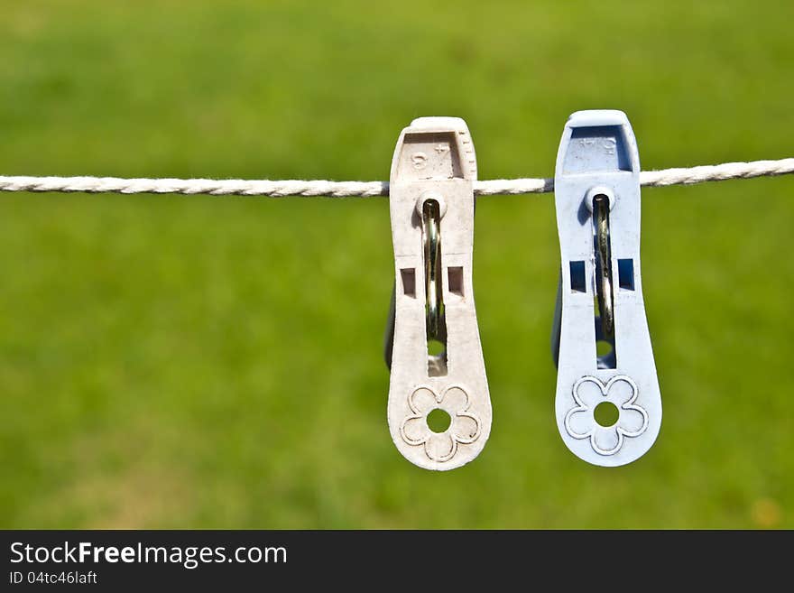 Colored clothespins on a green background. Colored clothespins on a green background