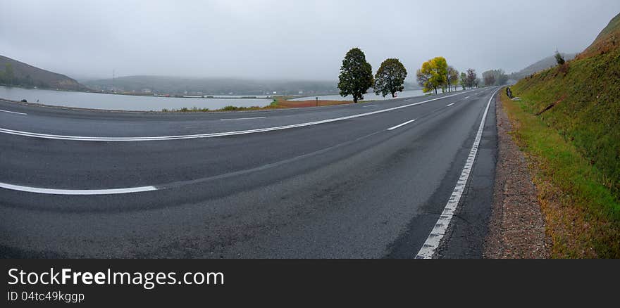 Autumn colors along a road on a foggy morning. Autumn colors along a road on a foggy morning