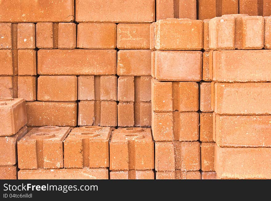 Common quality building bricks stacked ready for use.