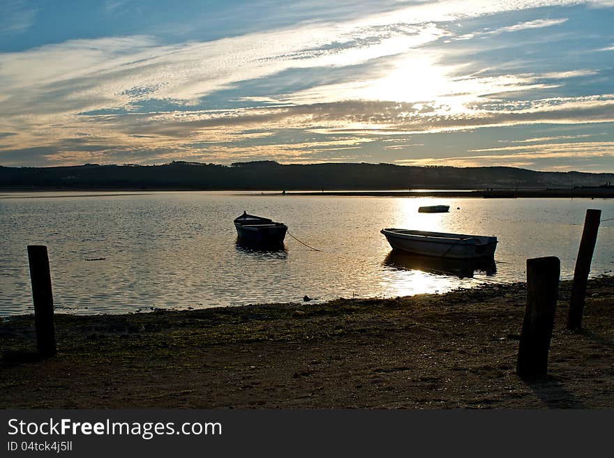 This image is from Foz-Do-Arelho, Portugal. Shows a traditional fishing port at sunset. This image is from Foz-Do-Arelho, Portugal. Shows a traditional fishing port at sunset