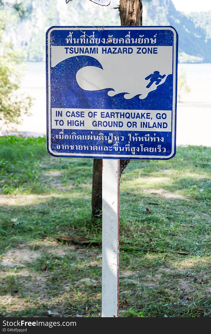 Blue tsunami hazard zone warning sign on the beach. Blue tsunami hazard zone warning sign on the beach