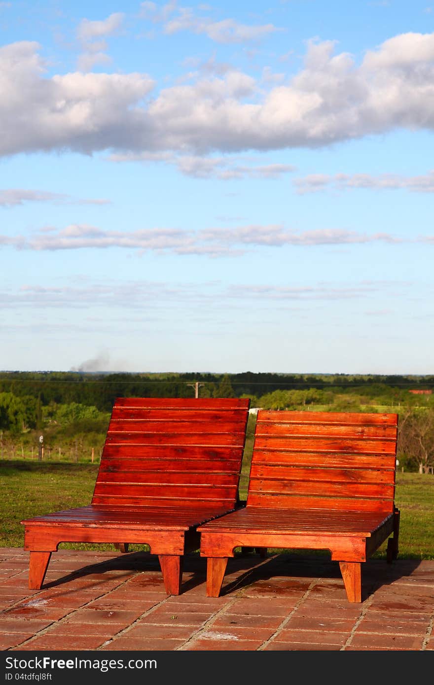 Two sun loungers under the sky.