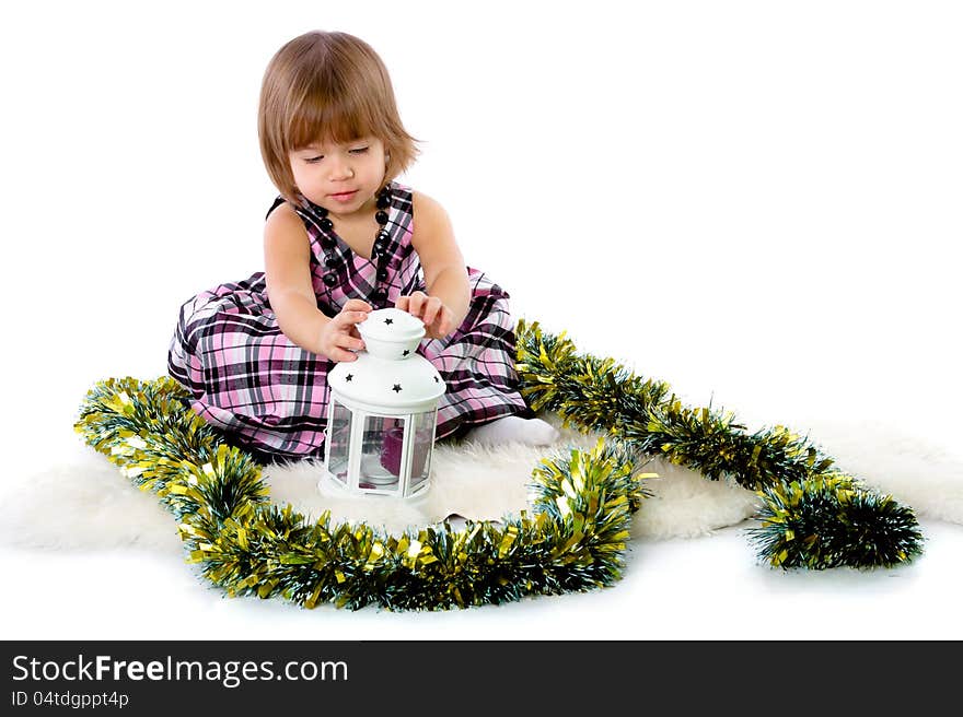 Little girl playing with baubles. on white background