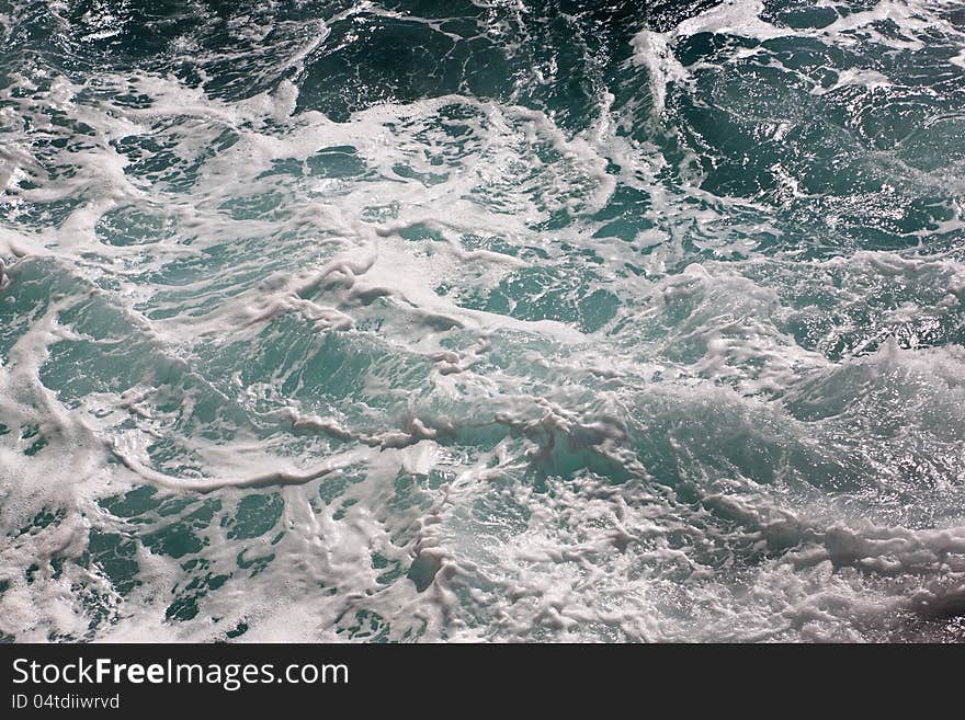 Splash of seawater with waves and sea foam. Splash of seawater with waves and sea foam