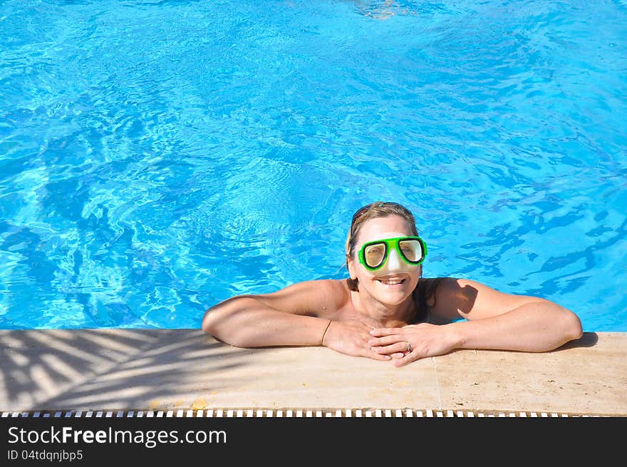 Beautiful woman in a swimming pool, wearing a mask