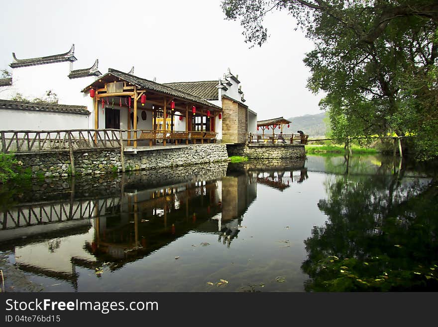 This is a traditional Pavilion in China, and the reflection of tree and pavilion make it more attractive. This is a traditional Pavilion in China, and the reflection of tree and pavilion make it more attractive.