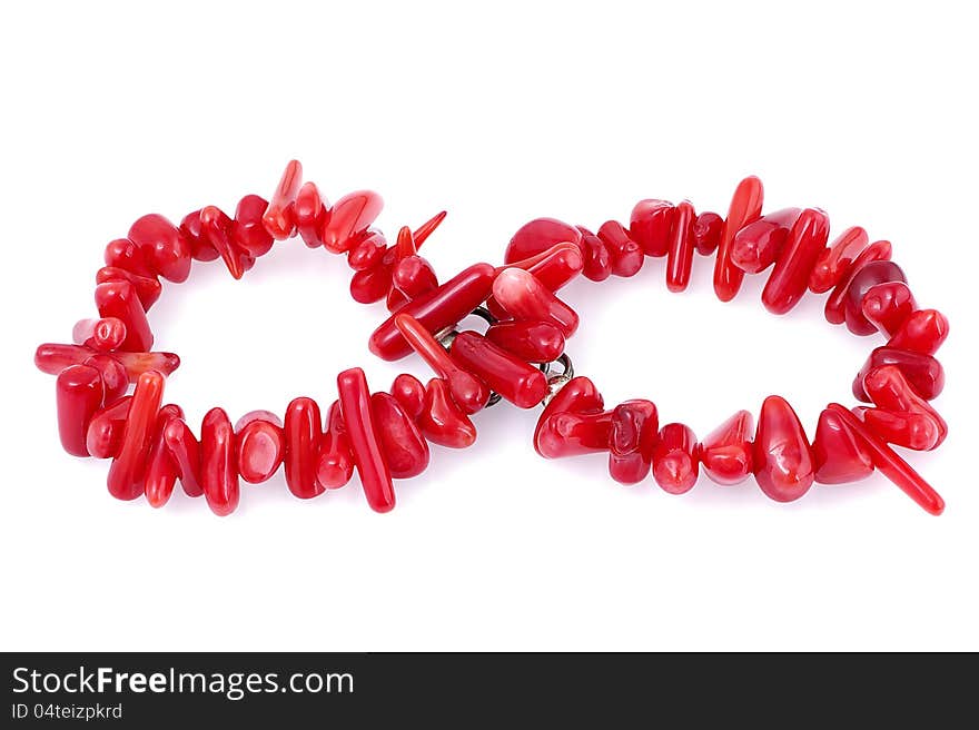 Natural coral bracelet laid out as infinity symbol, on white background. Natural coral bracelet laid out as infinity symbol, on white background.