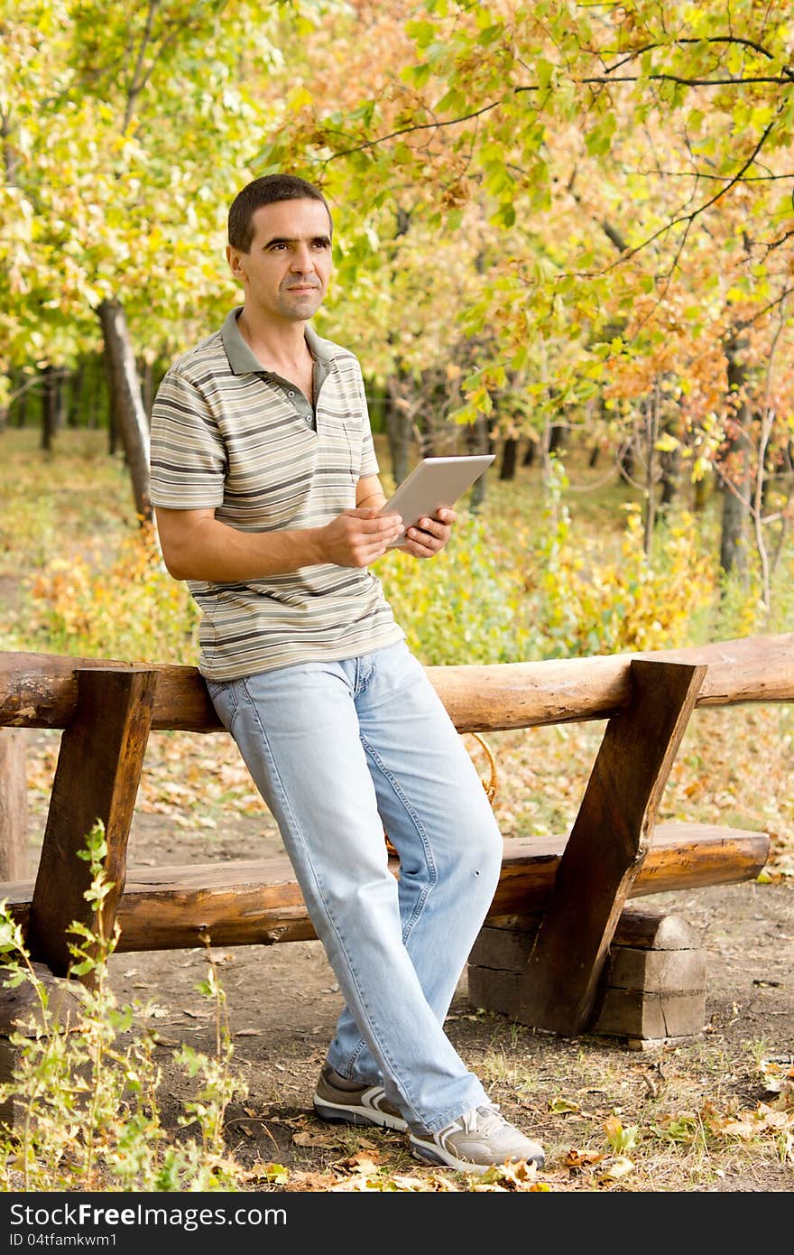 Man using a tablet in woodland