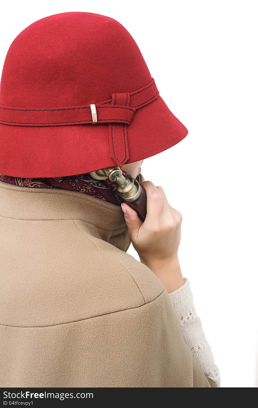 Old-fashioned woman in red hat holding telephone receiver and talking or listening. Old-fashioned woman in red hat holding telephone receiver and talking or listening