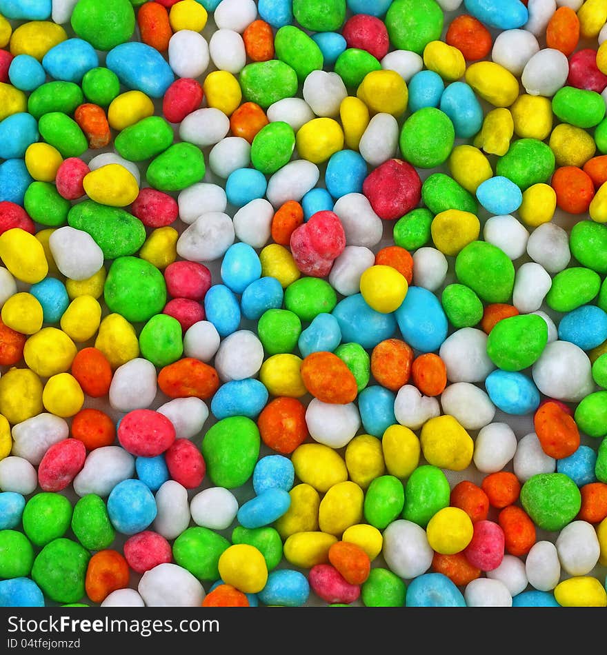 Colorful candies piled on white tablecloth background. Colorful candies piled on white tablecloth background