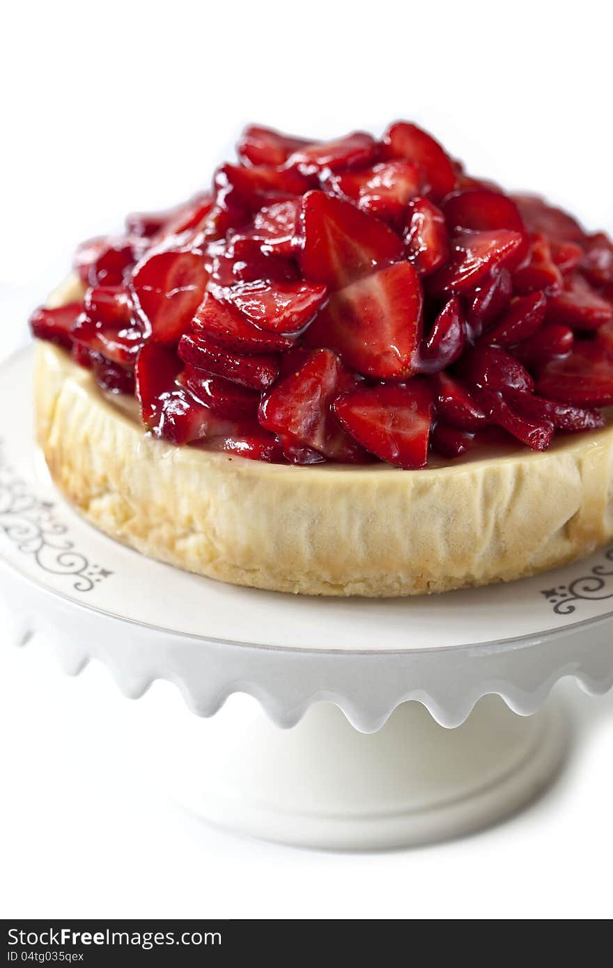 Cheesecake with strawberries on a white plate