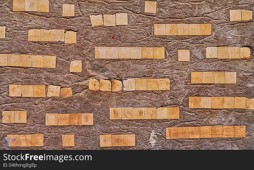 Concrete wall background or texture with ceramic pieces