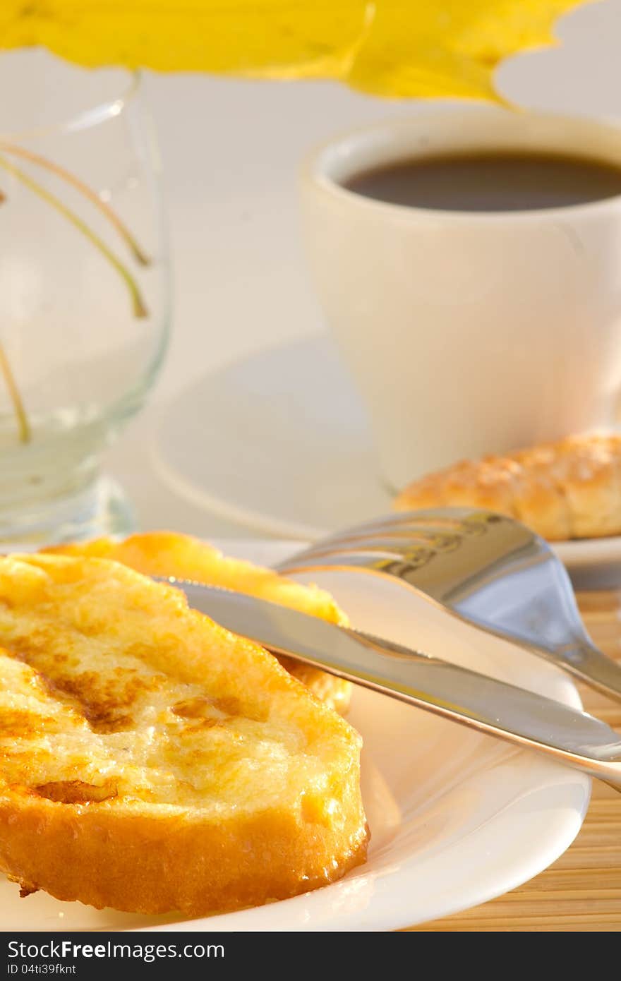 Coffee cup and sweet toast with autumn leaves