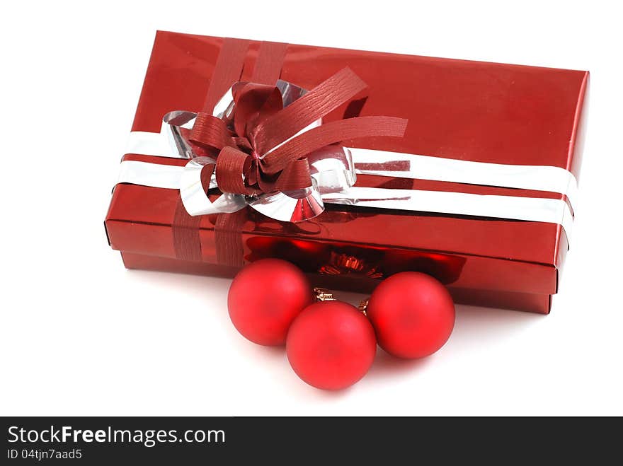 Gift box with red christmas baubles on white background. Gift box with red christmas baubles on white background