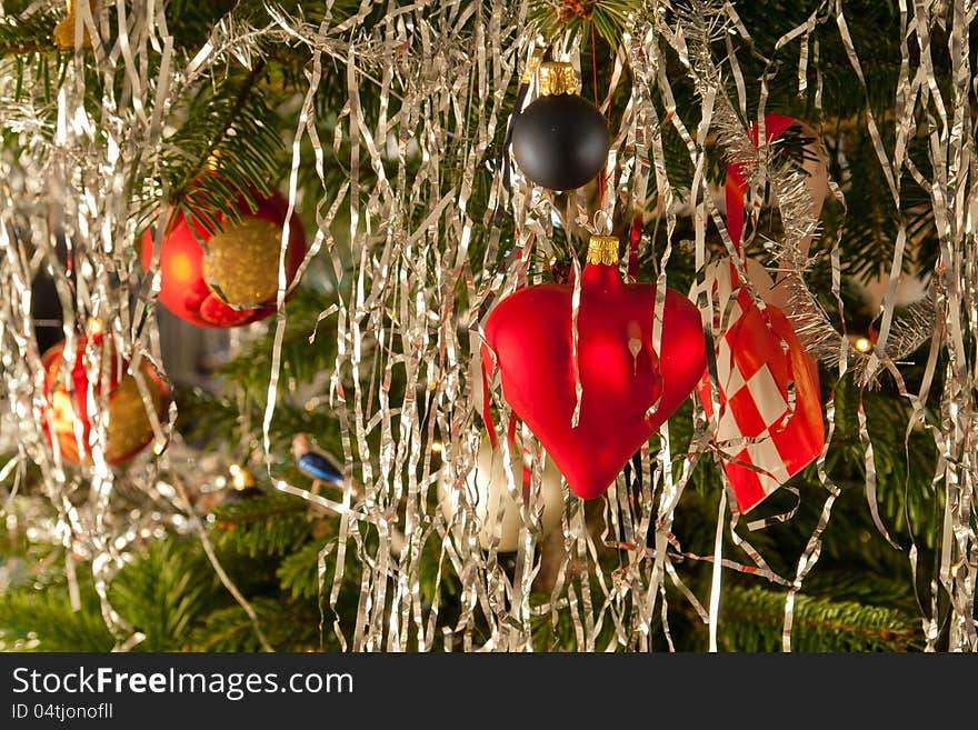 Christmas decoration red golden balls and hearts on a beautiful festive tree. Christmas decoration red golden balls and hearts on a beautiful festive tree