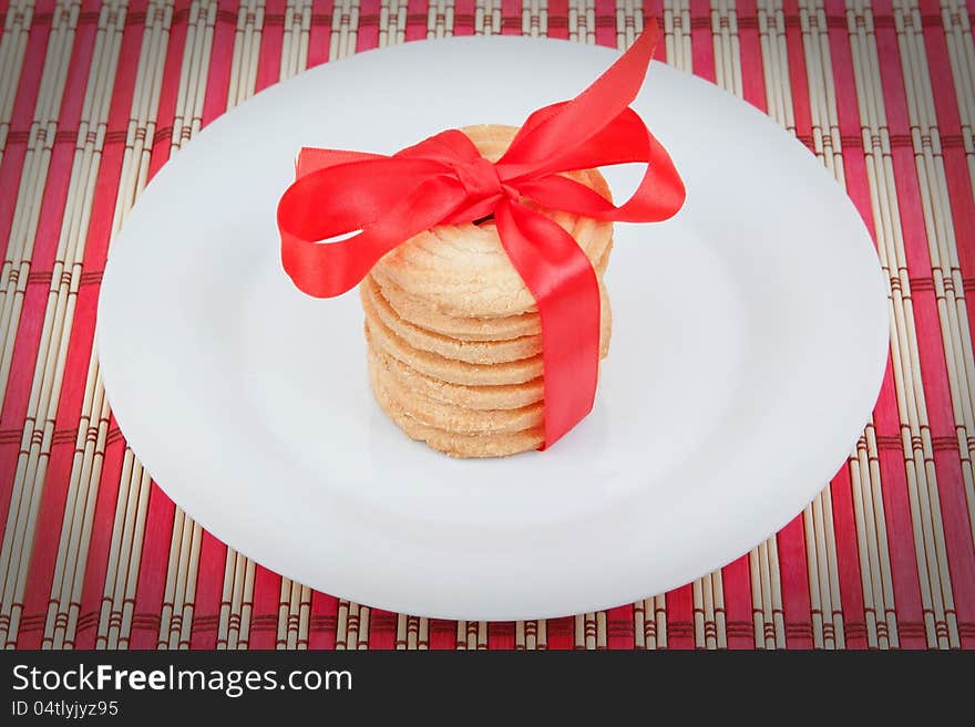 Christmas cookies in a plate with a bow on a napkin. Christmas cookies in a plate with a bow on a napkin.