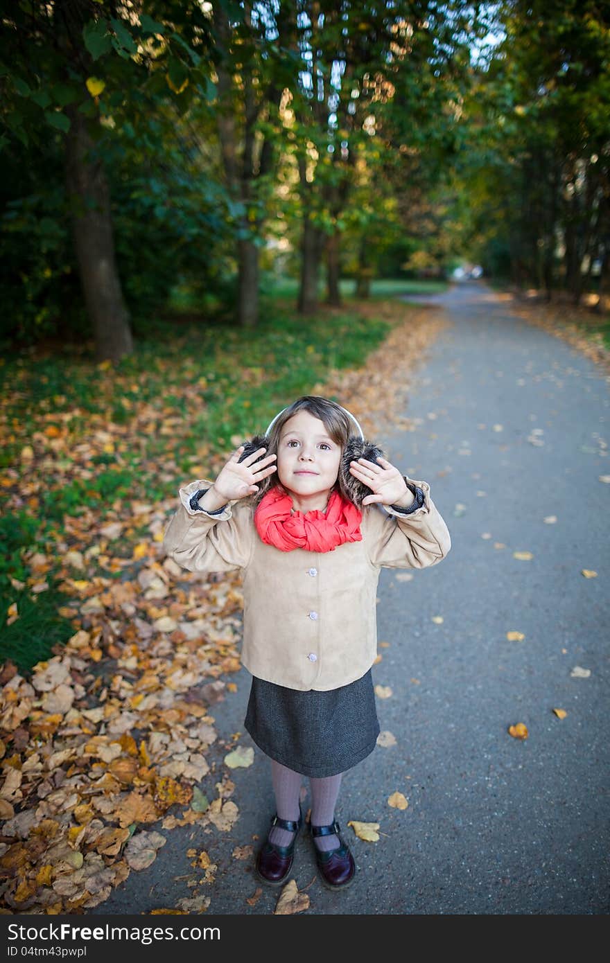 Small girl outdoor in the park with yellow leaves. Small girl outdoor in the park with yellow leaves