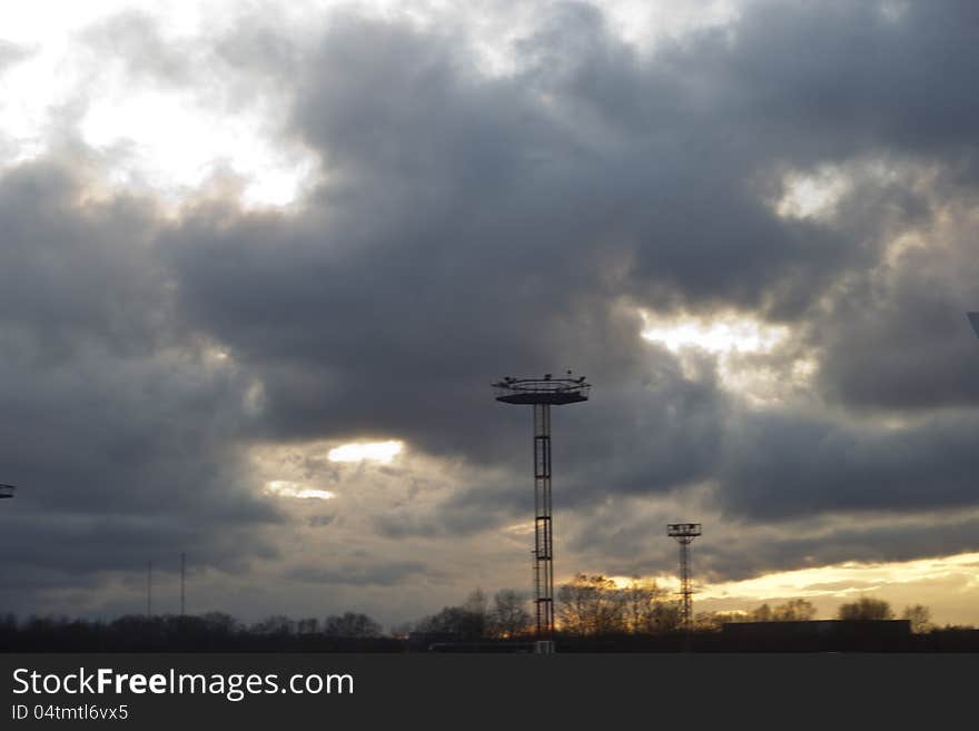 The storm sky over the airport in beams of the coming sun