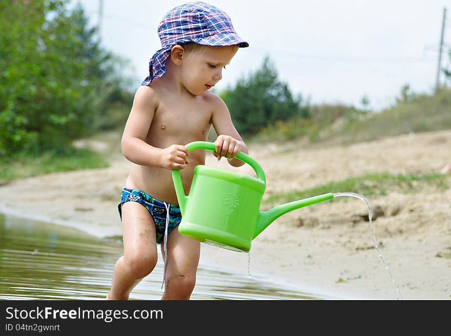 Little Boy Playing On The Beach