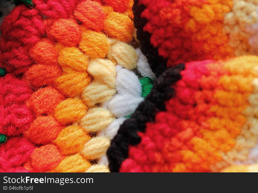 Bright, vivid & multicolored handwoven woolen table cloth closeup photo. The colors of the cloth include red, orange, yellow, green and pink. Bright, vivid & multicolored handwoven woolen table cloth closeup photo. The colors of the cloth include red, orange, yellow, green and pink.