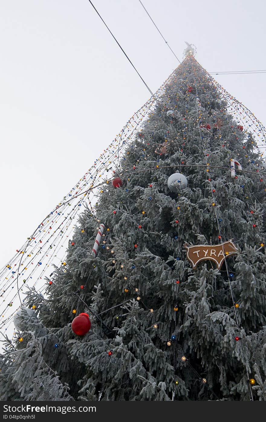 Frosty Christmas tree with lights and decorations