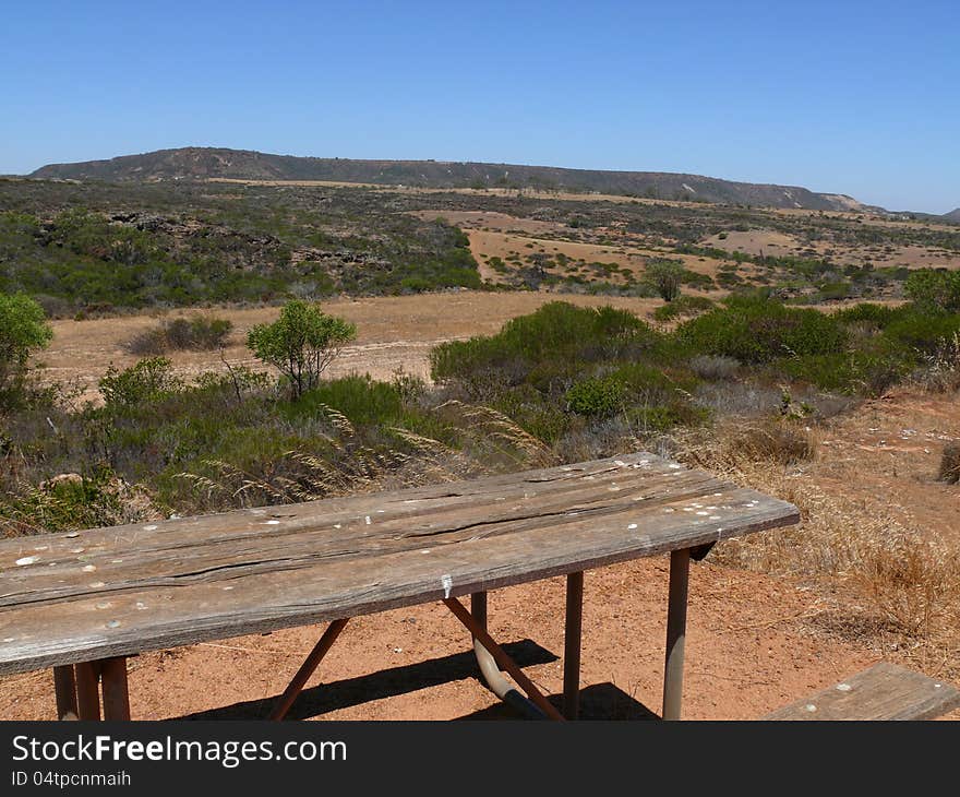 Western Australia, Landscape of the hilly savannah with small bench and table. Western Australia, Landscape of the hilly savannah with small bench and table.