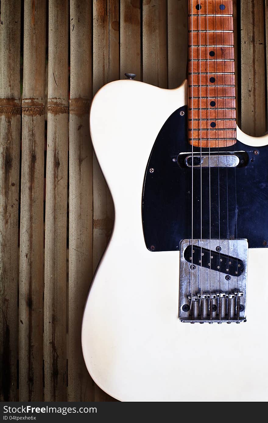 Grunge sticks wooden background with electric guitar