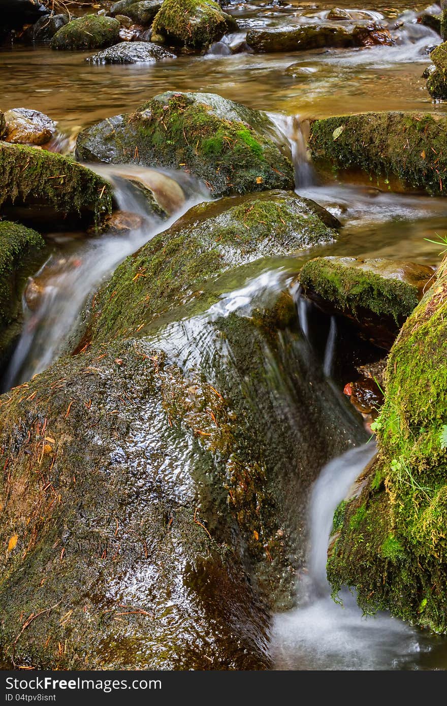 Beautiful veil cascading waterfall, mossy rocks