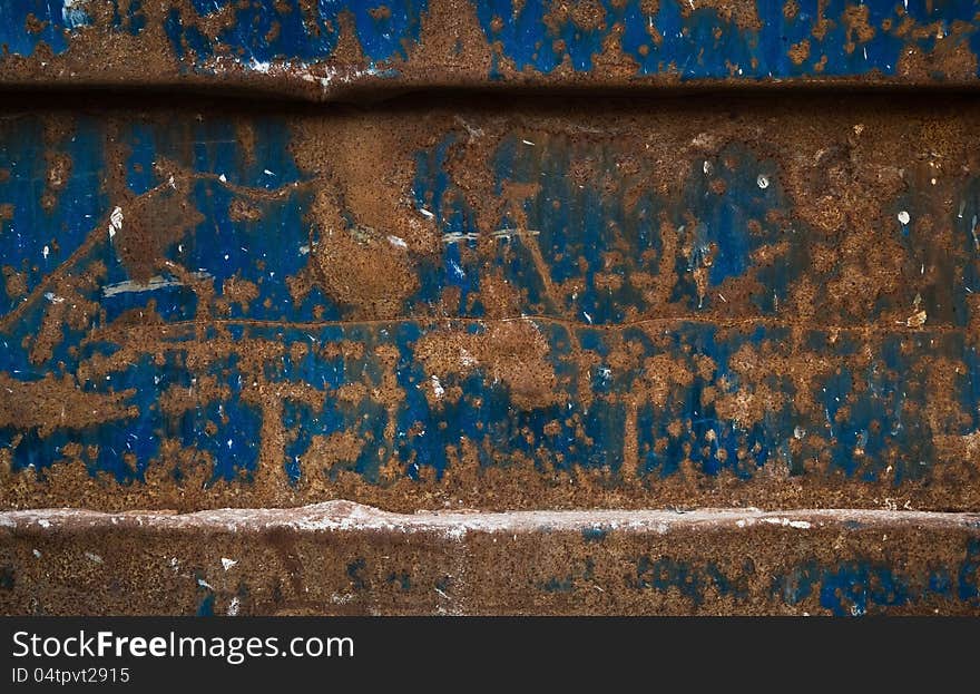 This is a really old and rusty blue painted metal dumpster. This is a good color contrast... blue and orange is like hot and cold. This is a really old and rusty blue painted metal dumpster. This is a good color contrast... blue and orange is like hot and cold.