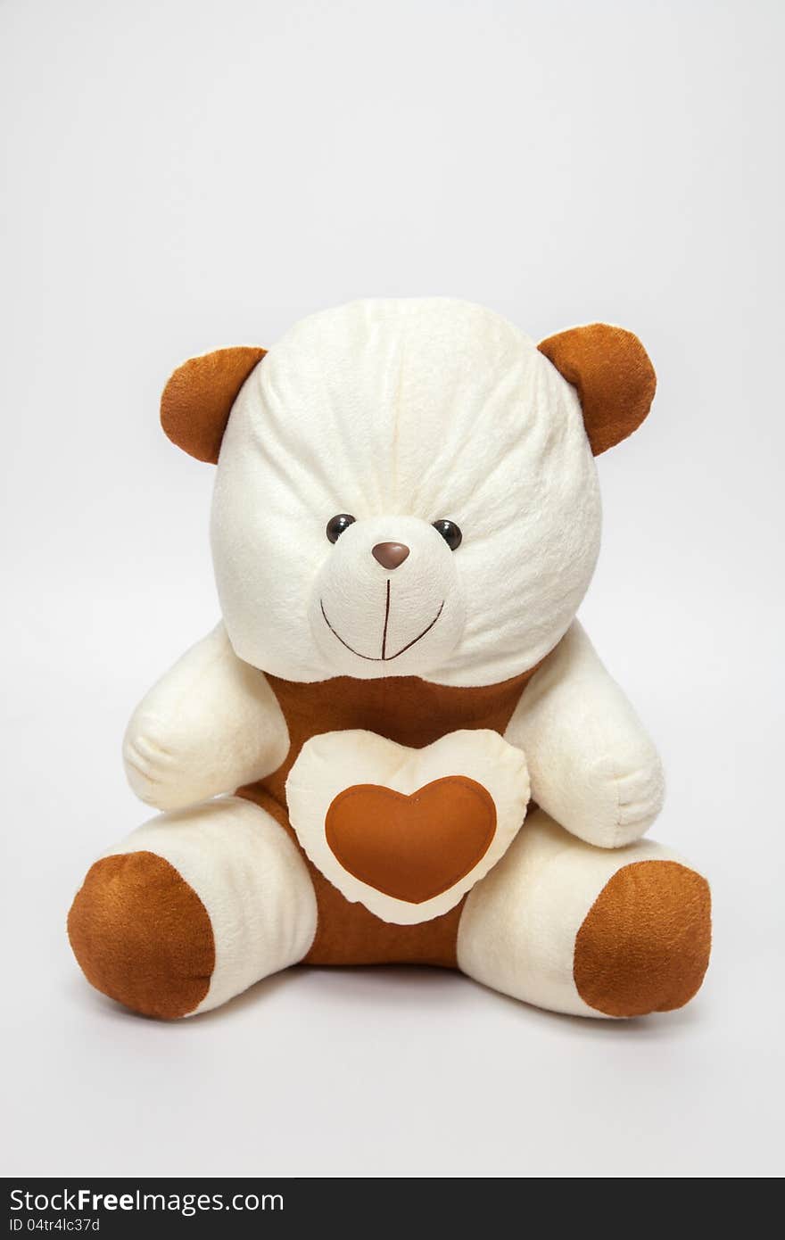 A teddy-bear with heart, over white white,  Image may be useful for Valentines. A teddy-bear with heart, over white white,  Image may be useful for Valentines.